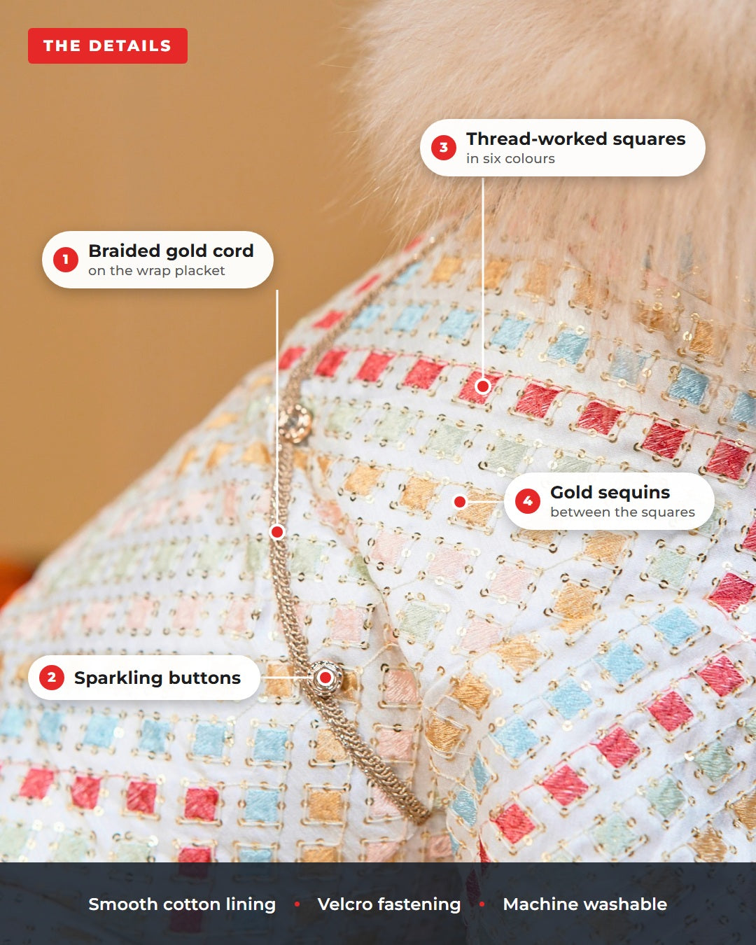 Close up of the Satrangi dog kurta, labelled: braided gold cord on the wrap placket, thread worked squares in six colours, gold sequins between the squares, sparkling buttons