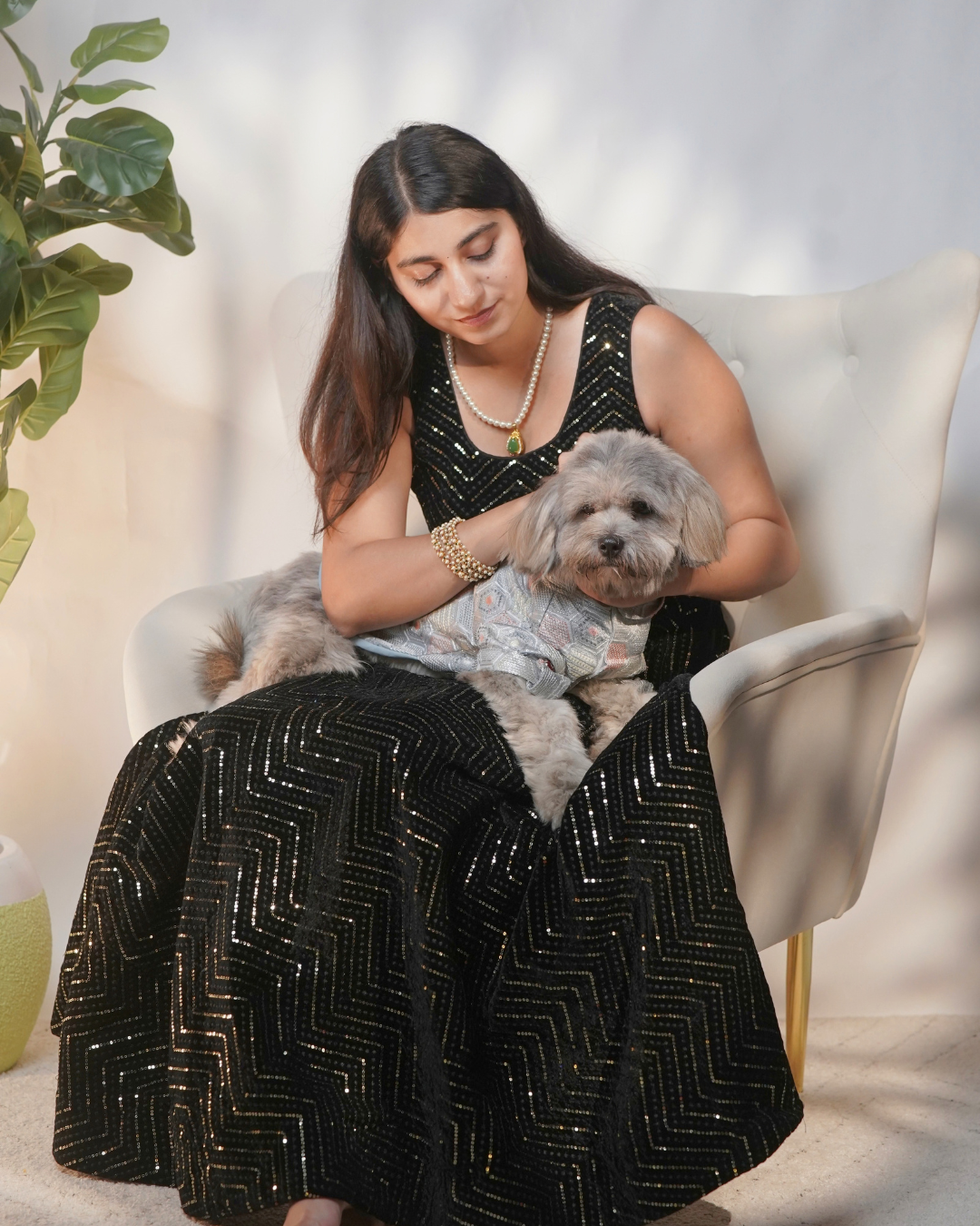 Woman in a black outfit holding a Shih Tzu wearing the Chandi Mehfil dog kurta on her lap